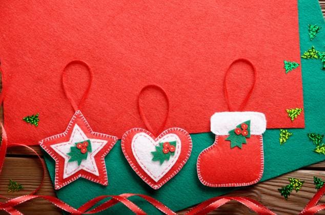 Handmade rustic Christmas tree decorations with red and green felt on wooden table Handmade rustic Christmas tree decorations with red and green felt on wooden table Copyright: xZoonar.com OlenaxMykhaylovax 17811318