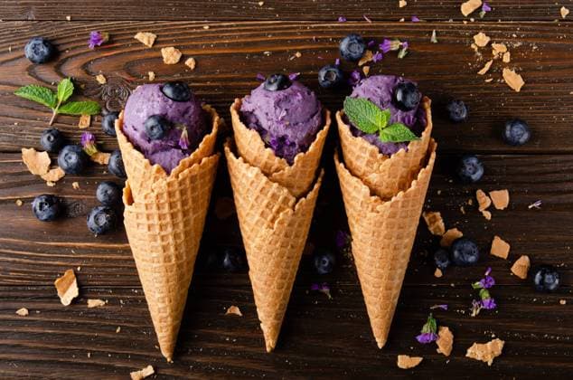 Flat lay view at wafer cones with blackberry icecream on wooden kitchen table Flat lay view at wafer cones with blackberry icecream on wooden kitchen table Copyright: xZoonar.com OlenaxMykhaylovax 17813948