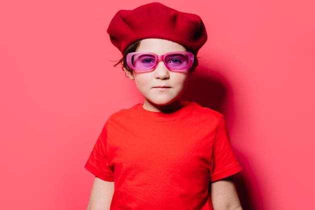 Young girl in trendy red casual outfit looking at camera and standing against pink background, Model released HodeiUnzueta_ID13011_396079_007 Copyright: xHodeixUnzuetax MR