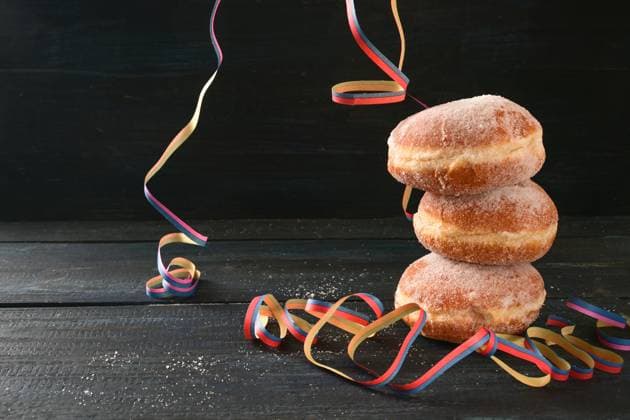 Stacked Berliner doughnuts or Krapfen and some party streamers against a dark rustic background, often served on New Year and carnival, copy space, selected focus Stacked Berliner doughnuts or Krapfen and some party streamers against a dark rustic background, often served on New Year and carnival, copy space, selected focus, narrow depth of field Copyright: xZoonar.com MARENxWINTERx 18274594