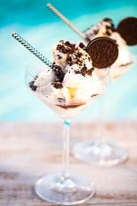 Vanilla sundae ice cream with chocolate sauce and cookies Vanilla ice cream with chocolate sauce and cookies by the pool Copyright: xZoonar.com DashaxPetrenkox 10799001