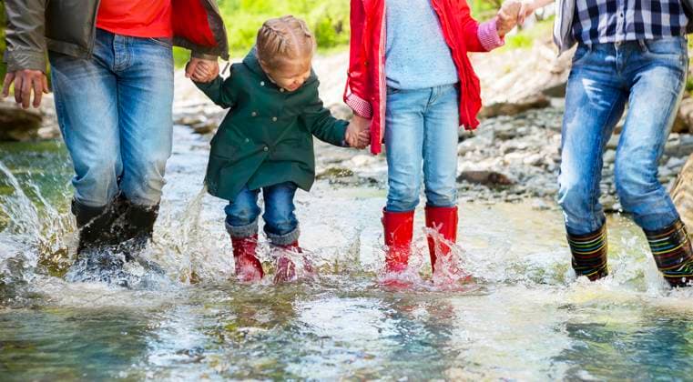 Happy family wearing rain boots jumping into a mountain river Happy family with two children wearing rain boots jumping into a mountain river ,model released, Symbolfoto Copyright: xZoonar.com DashaxPetrenkox 7381519 ,model released, Symbolfoto ,property released