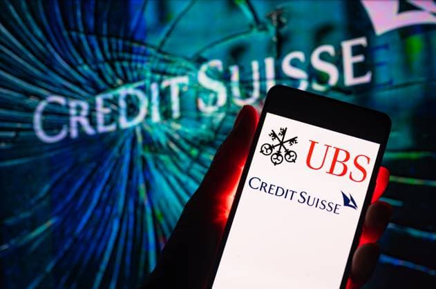 Credit Suisse - UBS Illustration Credit Suisse logo with UBS displayed on mobile with Credit Suisse logo seen in the background. On 19 March 2023 in Brussels, Belgium. (Photo illustration by Jonathan Raa NurPhoto) Brussels Belgium  Copyright: xJonathanxRaax originalFilename: raa-creditsu230319_npm40.jpg