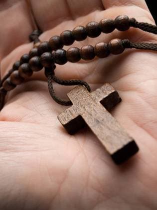 rosary in the hand with focus on the cross, shallow DOF Copyright: xVladimirxkoleticx xDesignxPicsx , 30436847 Copyright: LisaxF.xYoungx xDesignxPics 30436847