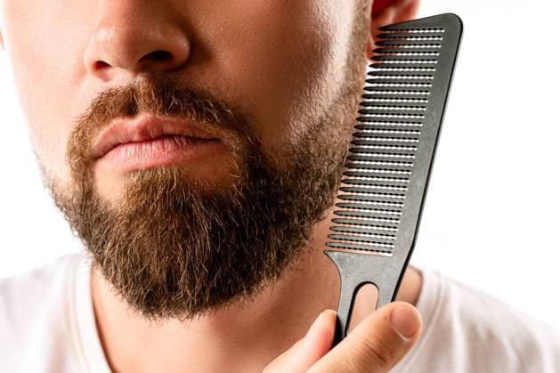 Well groomed man combing his thick beard Handsome well groomed man combing his beard ,model released, Symbolfoto Copyright: xZoonar.com blackdayx 18594438 ,model released, Symbolfoto ,property released