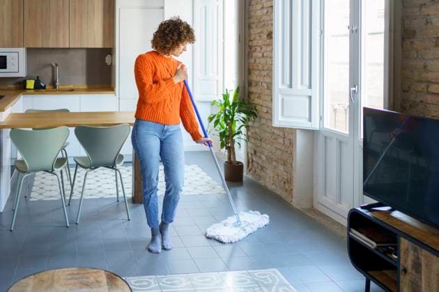 Woman with mop cleaning on floor at home model released, Symbolfoto property released, JSMF02681