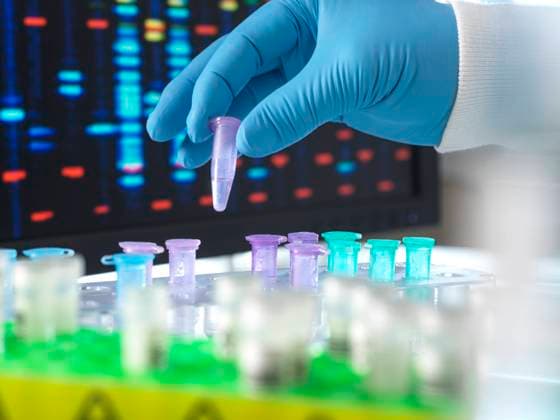 Hand of scientist holding DNA sample test tube in laboratory model released, Symbolfoto property released, ABRF01056