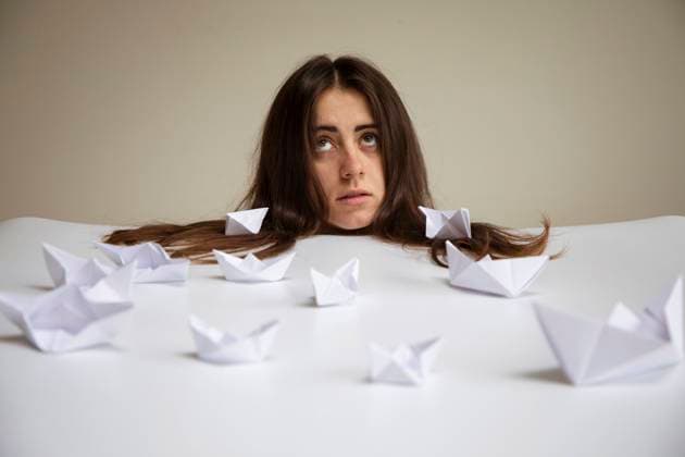 Creative Highlights Symbolbilder Young woman with paper boats on table in front of wall model released, Symbolfoto, AXHF00341