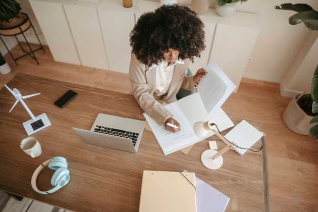 Businesswoman with Afro hairstyle taking notes in office model released, Symbolfoto property released, RCPF01663