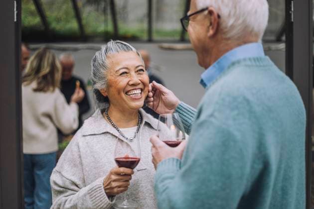 Senior man touching face of happy female friend at dinner party Sweden, Stockholm, model released, property released Copyright: xMaskotx , MA100194 MA100194