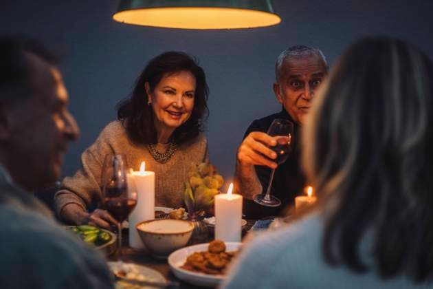 Smiling retired woman enjoying dinner with friends at party Sweden, Stockholm, model released, property released Copyright: xMaskotx , MA100250 MA100250