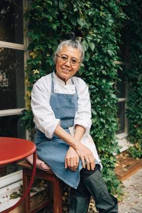 Portrait of smiling senior female chef sitting outside restaurant Sweden, Stockholm, model released, property released Copyright: xMaskotx , MA100304 MA100304