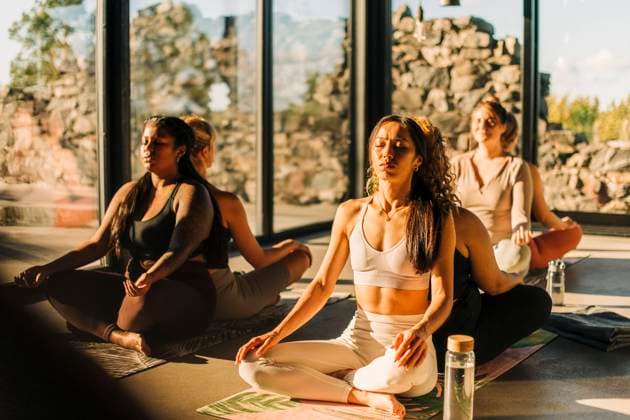 Female friends exercising while sitting back to back at retreat center Sweden, Stockholm, model released, property released Copyright: xMaskotx , MA100374 MA100374