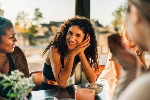 Happy woman leaning on elbows while talking to female friends at retreat center Sweden, Stockholm, model released, property released Copyright: xMaskotx , MA100402 MA100402