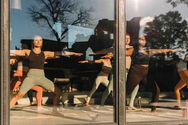 Female friends practicing yoga together at retreat center seen through glass Sweden, Stockholm, model released, property released Copyright: xMaskotx , MA100433 MA100433