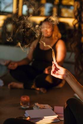 Hand of woman holding burning sandalwood at retreat center Sweden, Stockholm, model released, property released Copyright: xMaskotx , MA100438 MA100438