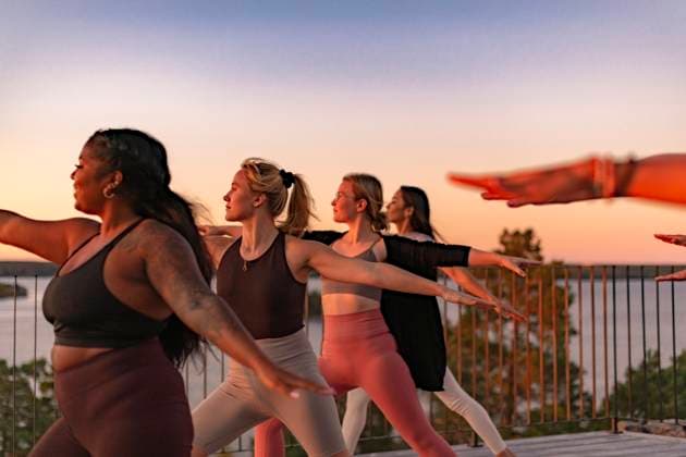 Female friends doing yoga on patio at sunset Sweden, Stockholm, model released, property released Copyright: xMaskotx , MA100466 MA100466