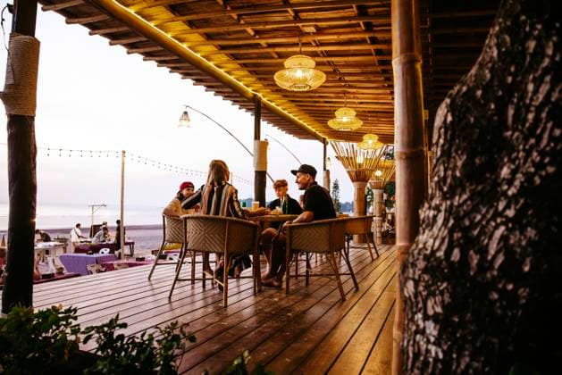 Family enjoying together while sitting on chairs at restaurant porch during vacation Thailand, Ko Lanta, model released, property released Copyright: xMaskotx , MA100557 MA100557