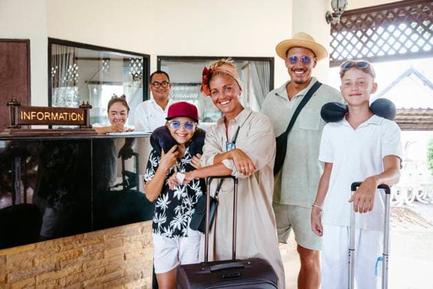 Portrait of happy family with receptionists standing in tourist resort Thailand, Ko Lanta, model released, property released Copyright: xMaskotx , MA100563 MA100563