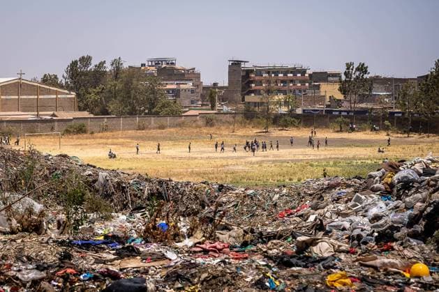 February 23, 2023, Nairobi, Kenya: View of a school behind the waste mountains of Dandora dumpsite. Dandora is the biggest dumpsite in East Africa and is the destination of the solid waste generated by Nairobi. It has been declared full in 1996 but is still operating and a lot of people, including children, go there looking for plastic, food or clothes they can sell. Nairobi Kenya - ZUMAs197 20230223_zab_s197_094 Copyright: xSimonexBoccacciox