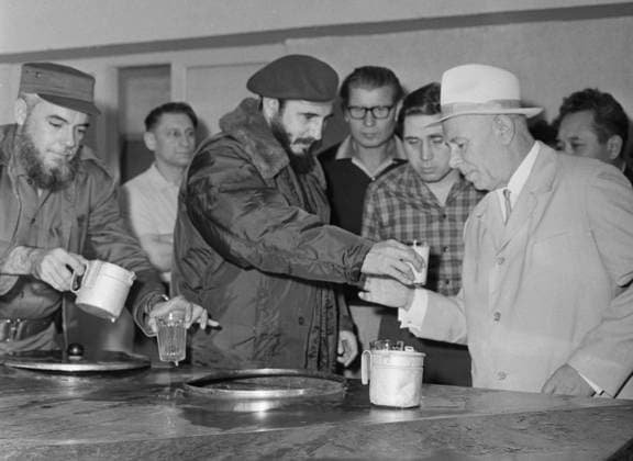 Cuba. December, 1963-January, 1964. Prime minister of Cuba Fidel Castro (2nd L front) and Secretary of the Central Committee of the Communist Party of the Soviet Union Nikolai Podgorny (R) visit a cattle farm and try milk. The exact date and location of the photograph is unknown. Valentin Sobolev TASS  32435514