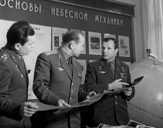 Moscow, USSR. February, 1966. Heroes of the Soviet Union, Soviet cosmonauts Pavel Popovich, Alexei Leonov and Yuri Gagarin (L-R) look at the pictures, taken by the Luna-9 space station, during the lessons at the Zhukovsky Air Force Engineering Academy. The exact date of the photograph is unknown. Valentin Cheredintsev TASS  1418445