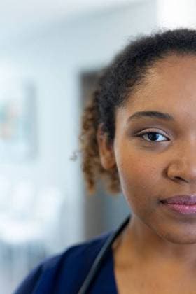 Vertical half face portrait of african american female doctor in hospital corridor, with copy space Vertical half face portrait of african american female doctor in hospital corridor, with copy space. Hospital, medical and healthcare services., model released, , property released, Cape Town, South Africa, 2022-10-21T22:00:00.000Z, 3876656.jpg, people,vertical,half face,face portrait,african american,female doctor,hospital,corridor,copy space,medical,healthcare,service,medicine,doctor,clinic,care,health,patient,treatment,illness,disease,nurse,foreman,occupation,successful worker,professional,stethoscope,virus,peoplework,half,face,portrait,african,american,female,copy,space Young Adult,Woman,Female,Multiracial