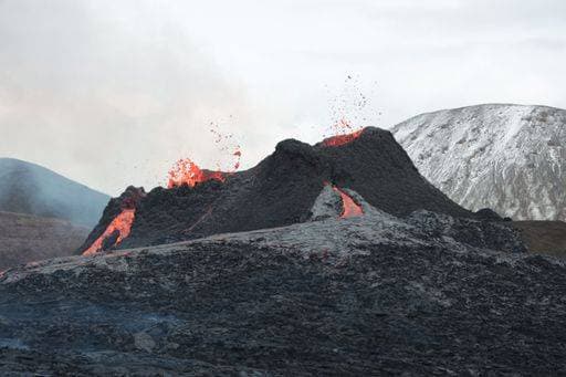 Creative Highlights World RECORD DATE NOT STATED A volcanic eruption with glowing orange lava flow surrounded by a pool of bubbling magma *** einer vulkanische eruption mit glühend Orangefarbene lavä fließen umgeben indem einer Bassin des blubbernd magma 15054114
