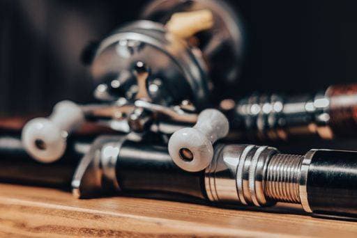 RECORD DATE NOT STATED A closeup of fishing line on the table next to a reel. Its reel shows the intricate detail of the fishing line *** einer closeupe des Angeln Linie am der Tisch nächsten an einer reel seiner reel zeigt der verschlungene einzelheit des der Angeln Linie 16416994