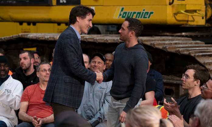 April 3, 2023, Val d Or, PQ, Canada: A worker rises to ask Prime Minister Justin Trudeau shakes hands with workers following a town hall meeting at a lithium mine near La Corne, Que., Monday, April 3, 2023. Val d Or Canada  - ZUMAc35_ 20230403_zaf_c35_133 Copyright: xAdrianxWyldx