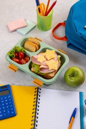 Healthy school lunch box with sandwich and salad on the workplace near backpack. School supplies, books, apple and a bottle of water. Healthy school lunch box with sandwich and salad on the workplace near backpack. School supplies, books, apple and a bottle of water. Copyright: xZoonar.com SvetlanaxKhutornaiax 19419302