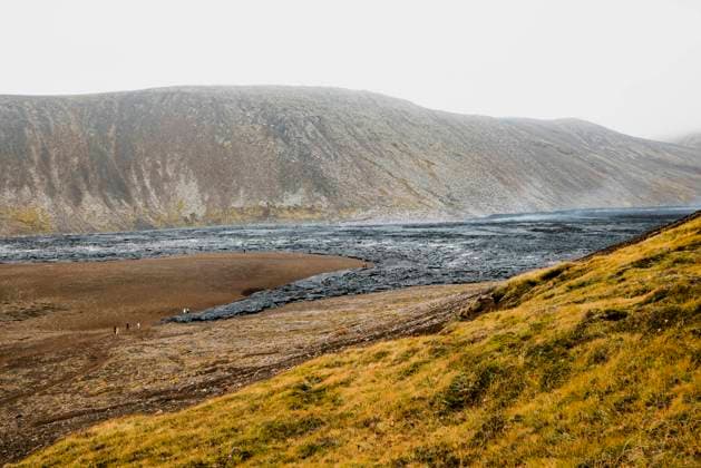 Near Geldingadalir active Volcano steam coming up from warm lava rocks, from recent 2022 Meradalir eruption Geldingadalir active Volcano, errupting in 2021 - Fagradalsfjall and 2022 -Meradalir. Still hot lava rocks, steam comping up from the grounds. Dark grey, black volcanic rocks in Iceland. Dramatic view of lava rocks cold cloudy autumn day in Iceland. Copyright: xZoonar.com ZigaxPlahutarx 19561770