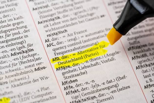 Deutsche Parteien: AfD, Symbolbilder Bavaria, Germany - 2 April 2023: The word AfD marked with a highlighter in a German dictionary Duden. Meaning, language and definition concept *** Das Wort AfD mit einem Textmarker in einem deutschen Wörterbuch Duden markiert. Bedeutung, Sprache und Definition Konzept