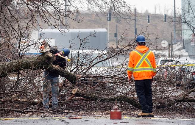 April 6, 2023, Montreal, PQ, Canada: Workers clear a fallen tree from a street following an ice storm in Montreal, Thursday, April 6, 2023. Montreal Canada  - ZUMAc35_ 20230406_zaf_c35_010 Copyright: xGrahamxHughesx