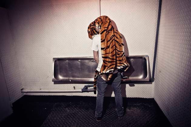 Party people, Copenhagen, Denmark A man with a tiger custome on hos shoulders is peeing at a night club toilet. Denmark 2010. Copenhagen Denmark  Copyright: xGonzalesxPhoto KennethxNguyenx