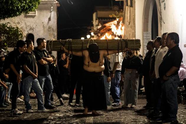 México: Good Friday in Taxco Guerrero Penitent citizen on his way to the church Penitents of Taxco carried out their traditional procession of the Three Fallen among cobblestone streets accompanied by sounds and prayers. During the procession you can see how the penitents flagellate themselves or carry sticks of thorns to demonstrate their faith towards God. Tourists and pilgrims arrived in the city to witness this traditional ritual. Taxco Guerrero Mexico Taxco Guerrero Copyright: LuisxSalgado