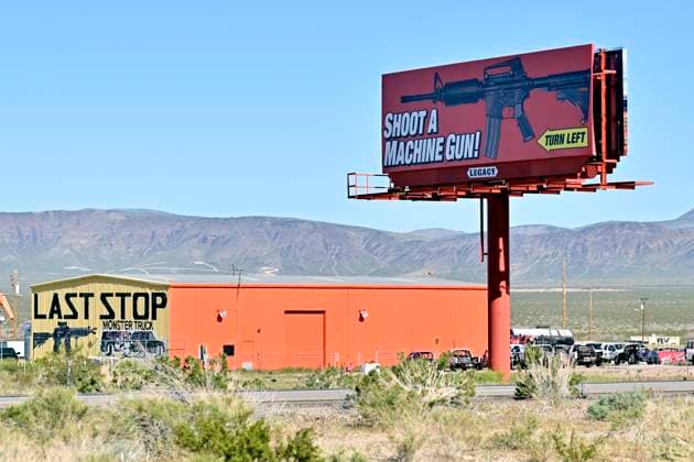 April 10, 2023 - White Hills, Arizona, U.S. - A roadside billboard advertises with an image of an AR style rifle, to shoot a machine gun at the Arizona Last Stop shooting range in White Hills, Arizona. White Hills USA - ZUMAbk3_ 20230410_zaf_bk3_006 Copyright: xDavidxBeckerx