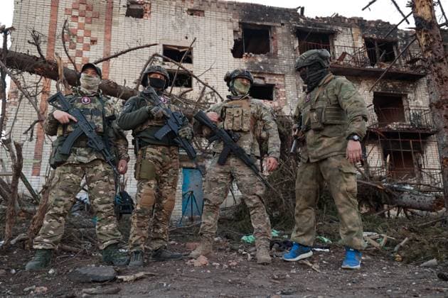 UKRAINE, DONETSK REGION - APRIL 10, 2023: Wagner Group soldiers are seen by a damaged building in the city of Artyomovsk (Bakhmut). Artyomovsk is located in the Kiev-controlled area of the Donetsk People s Republic. The fight for the city continues. Valentin Sprinchak TASS  58348807