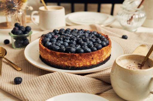 RECORD DATE NOT STATED A delicious vegan yogurt blueberry cake with coffee table on a white table *** einer Köstlich vegane yogurt Heidelbeere Kuchen mit Kaffee Tisch am einer weiß Tisch 1511905