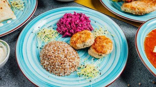 RECORD DATE NOT STATED A blue plate with fishcakes and buckwheat grains with a side of Beetroot salad *** einer Blau Teller mit fishcakes und Buchweizen Körner mit einer Bordwand des Beetroot Salat 10269325