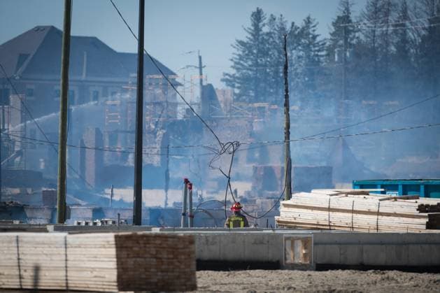 April 12, 2023, Vaughan, ONT, CANADA: A Firefighter walks through the damage as they continue to battle a large fire in a new housing development area near Pine Heights and Teston Road, in Vaughan, Ont., Wednesday, April 12, 2023. Vaughan CANADA  - ZUMAc35_ 20230412_zaf_c35_038 Copyright: xTijanaxMartinx