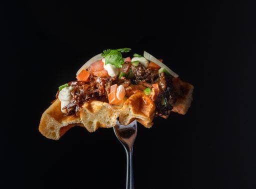 RECORD DATE NOT STATED A closeup shot of a waffle on a fork with salmon and onions *** einer closeupe erschossen des einer Waffel am einer Gabel mit Lachs und Zwiebeln 10543997