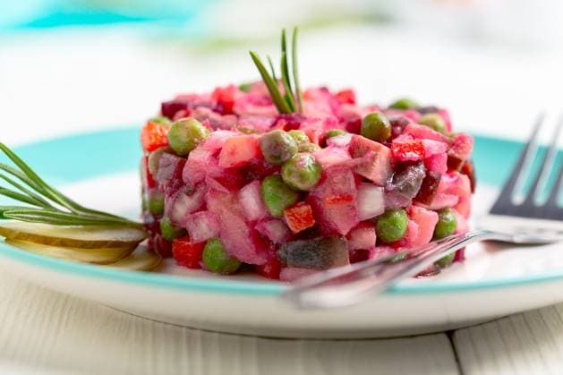 Vinaigrette - traditional Russian salad. Beetroot salad with mushrooms. Salad with beets, salted mushrooms, green peas, carrots and potatoes on a plate. Close up, copy space. Copyright: xZoonar.com MarinaxSaprunovax 19832276