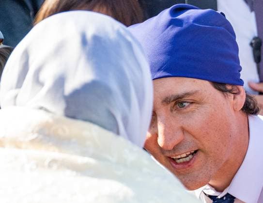 April 14, 2023, VANCOUVER, BC, CANADA: Prime Minister Justin Trudeau speaks with a woman outside after visiting with volunteers during Vaisakhi at the Khalsa Diwan Society in Vancouver, on Friday, April 14, 2023. VANCOUVER CANADA  - ZUMAc35_ 20230414_zaf_c35_154 Copyright: xEthanxCairnsx