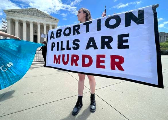 April 15, 2023, WASHINGTON, D.C, WASHINGTON, D.C, USA: A small group of pro-life demonstrators protest next to a Pro-choice rally in support of womenÃ¢â‚¬â ¢s abortion rights outside the Supreme Court in Washington, D.C. on April 15, 2023. The Supreme Court temporarily preserved access to mifepristone, a widely used abortion pill, in an 11th-hour ruling preventing lower court restrictions on the drug from coming into force. WASHINGTON, D.C. USA - ZUMAs139 20230415_zap_s139_026 Copyright: xStephenxShaverx