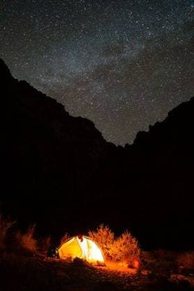 RECORD DATE NOT STATED An outdoor camping scene featuring a tent set up under a star-filled night sky, with a campfire burning in the foreground *** An&Verkauf Drauss Zelten Szene featuring einer Zelt setzen Aufwärts unterhalb einer Stern gefüllt Nacht sky, mit einer Lagerfeuer brennend ÊIn der Vordergrund 19040297