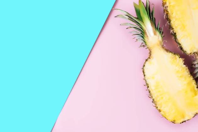 Cut halves of fresh pineapple on pastel pink and blue background. Exotic fruit Flat lay with cut halves of fresh pineapple on a pastel pink and blue background. Ingredient for Pina Colada. Exotic fruit. High quality photo Copyright: xZoonar.com LenaxIvanovax 16916225