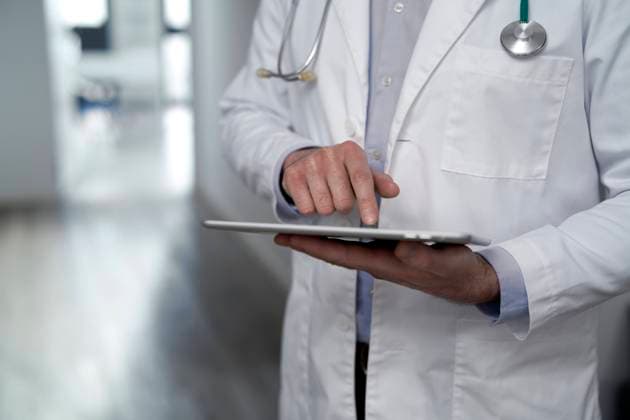 Doctor using tablet PC in clinic model released, Symbolfoto property released, ABIF01857
