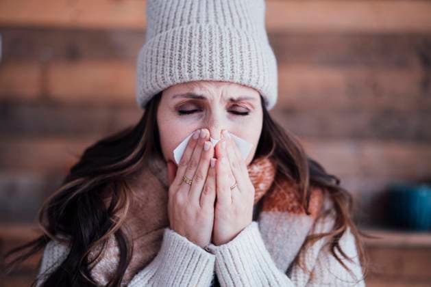 Sick woman wearing knit hat blowing nose model released, Symbolfoto property released, JOSEF17746