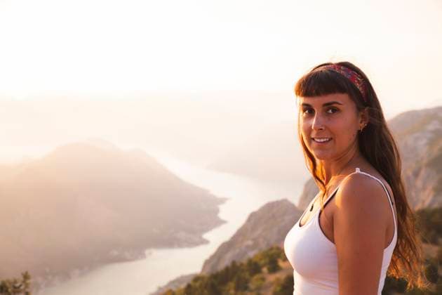 Smiling woman standing in front of mountains model released, Symbolfoto, PCLF00318